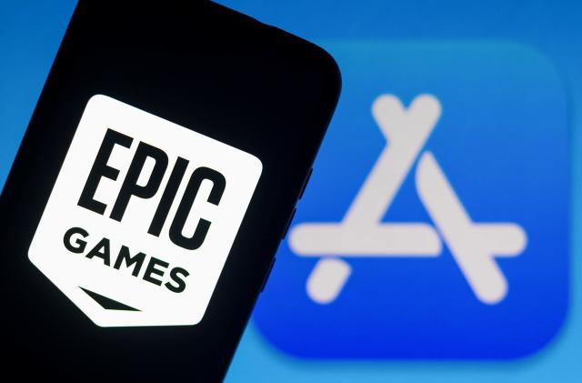 BRAZIL - 2021/09/13: In this photo illustration the Epic Games logo seen displayed on a smartphone with an Apple Store logo in the background. (Photo Illustration by Rafael Henrique/SOPA Images/LightRocket via Getty Images)