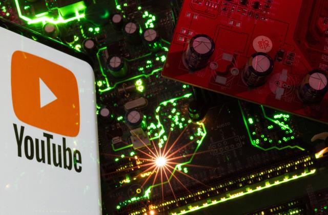 A smartphone with a displayed YouTube logo is placed on a computer motherboard in this illustration taken February 23, 2023. REUTERS/Dado Ruvic/Illustration