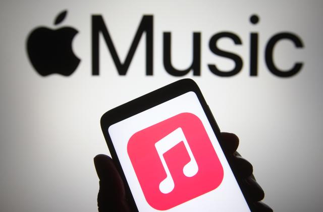 UKRAINE - 2021/04/18: In this photo illustration, Apple Music app seen displayed on a smartphone in front of Apple logo. (Photo Illustration by Pavlo Gonchar/SOPA Images/LightRocket via Getty Images)