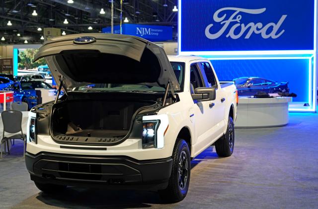 FILE - The Ford F-150 Lightning displayed at the Philadelphia Auto Show on Jan. 27, 2023, in Philadelphia. Ford says it’s reducing production of the F-150 Lightning electric pickup vehicle as it adjusts to weaker-than-expected electric vehicle sales growth.
