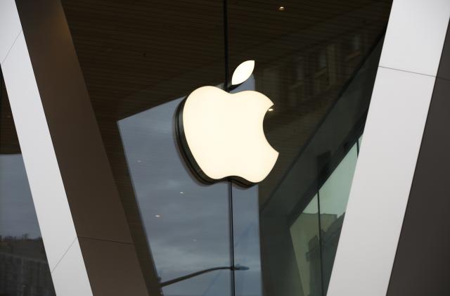 FILE - An Apple logo adorns the facade of the downtown Brooklyn Apple store in New York, Saturday, March 14, 2020. European Union regulators said they want to question Apple over accusations that it blocked video game company Epic Games from setting up its own app store, in a possible violation of digital rules that took effect in the 27-nation bloc Thursday, March 7, 2024. (AP Photo/Kathy Willens, File)
