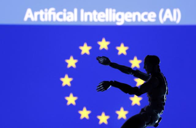 AI Artificial intelligence words, miniature of robot and EU flag are seen in this illustration taken December 21, 2023. REUTERS/Dado Ruvic/Illustration/File Photo