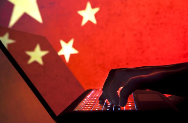 Cybercriminal, hacker China flag background.