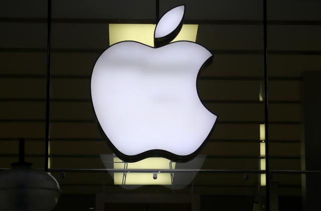 FILE - The Apple logo is illuminated at a store in the city center of Munich, Germany, Dec. 16, 2020. Apple has reversed course Friday, March 8, 2024, under regulatory pressure and cleared the way for a nettlesome adversary, video game maker Epic Games, to set up an alternative store for iPhone apps in Sweden. (AP Photo/Matthias Schrader, File)