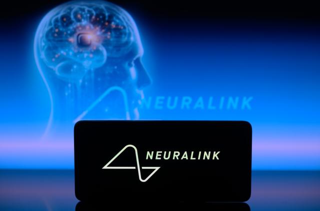 The Neuralink logo is displayed on a smartphone with Neuralink visible in the background in this photo illustration in Brussels, Belgium, on January 30, 2024. (Photo by Jonathan Raa/NurPhoto via Getty Images)