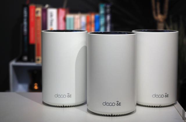 Image of three Deco 6E modules on a white table in front of a bookshelf.