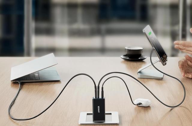 A charger on a table connected to multiple devices. 