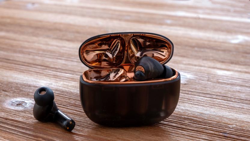 Creative's Aurvana Ace wireless headphones pictured on a table with the charging case open.