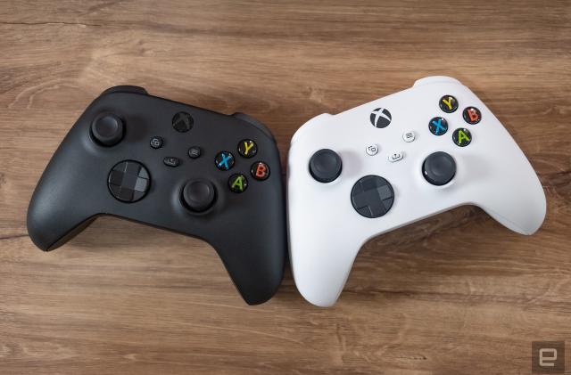 Two Xbox Wireless Controllers, one black and the other white.