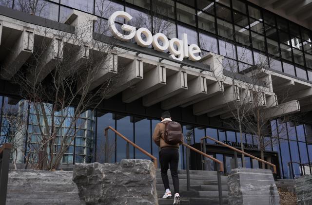 People arrive to the recently opened Google building in New York, Monday, Feb. 26, 2024. (AP Photo/Seth Wenig)