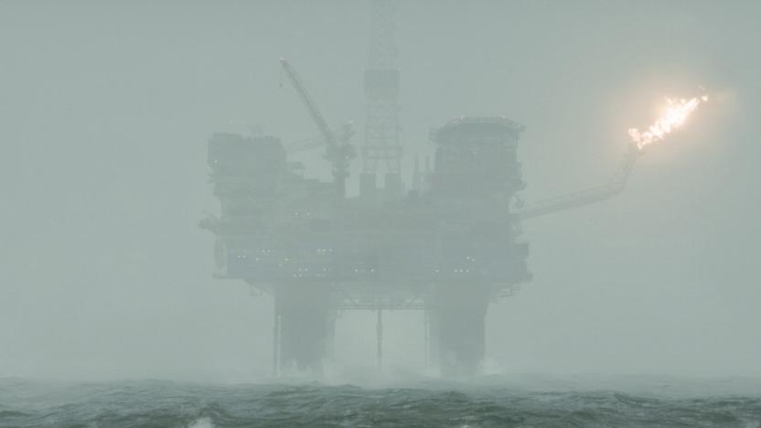 An oil rig obscured by heavy fog.