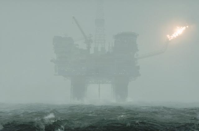 An oil rig obscured by heavy fog.