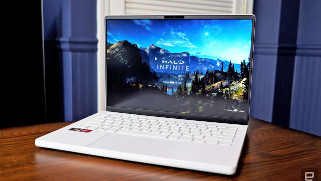 The ASUS ROG Zephyrus G14 (2022) in white sitting open on a table with Halo Infinite on the screen.