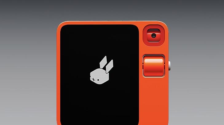 Rabbit R1 device against a gray background