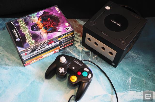 Nintendo GameCube in black, with controller and a stack of games
