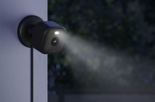 Image of the Blink Mini 2 outdoors with its LED spotlight activated.