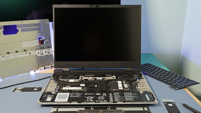 A Framework Laptop 16 laptop is shown open with its internals exposed and displayed in or around its casing.
