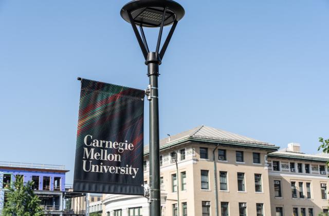 Pittsburgh, Pennsylvania  July 23, 2023: Carnegie Mellon University campus sign with school buildings in background