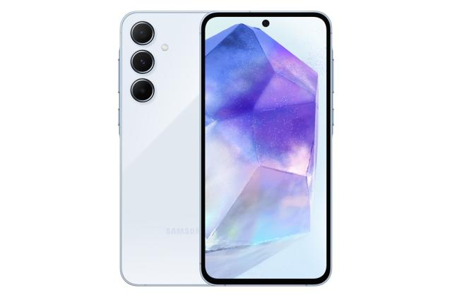 Press image of the midrange Samsung Galaxy A55 smartphone. The phone shows its front (with purple / blue wallpaper) and part of its back directly behind it. White background.