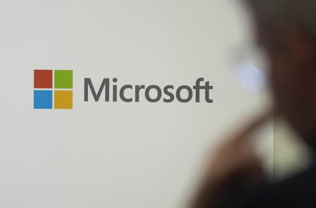 FILE - A logo of Microsoft is displayed during an event at the Chatham House think tank in London, Monday, Jan. 15, 2024. On Friday, Feb. 9, The Associated Press reported on stories circulating online incorrectly claiming Microsoft plans to “disable computers of users who share ‘non-mainstream content’ online.” (AP Photo/Kin Cheung, File)