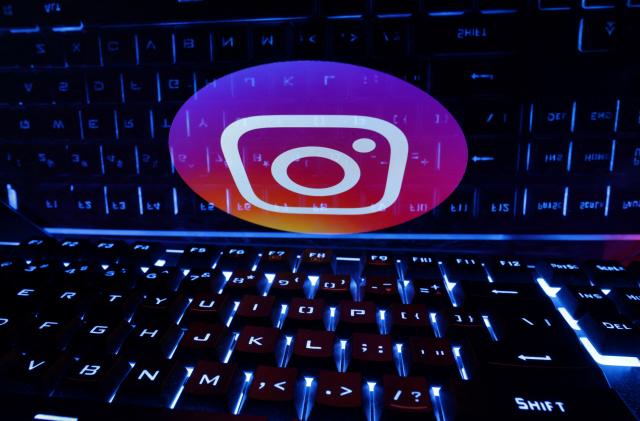 A keyboard is placed in front of a displayed Instagram logo in this illustration taken February 21, 2023. REUTERS/Dado Ruvic/Illustration