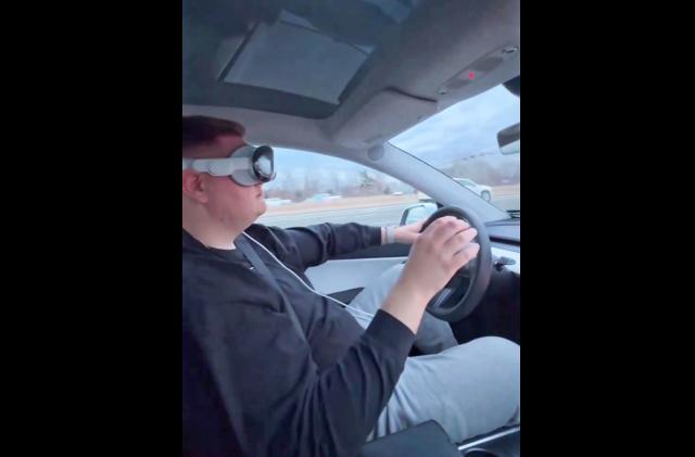 A screenshot from a video posted on X by Dante Lentini of him driving down the highway while wearing an Apple Vision Pro headset.  