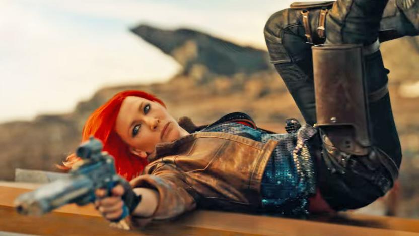 Cate Blanchett as Lilith in the movie Borderlands. In this action still, she lays on her back with legs in the air and aims a gun towards someone off camera.