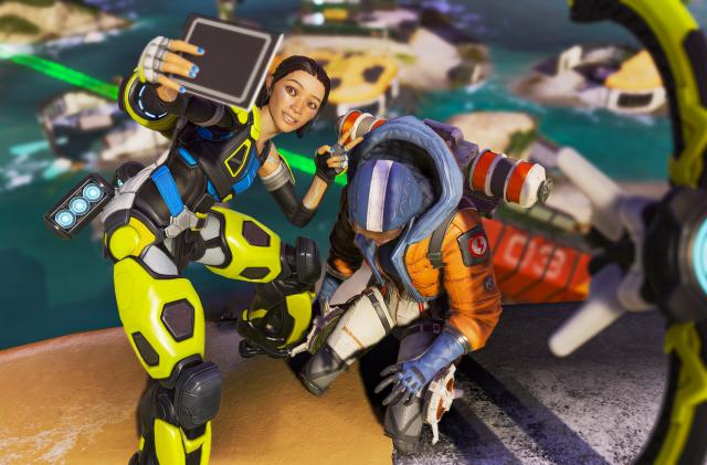 Apex Legends character Conduit takes a selfie with a downed opponent.