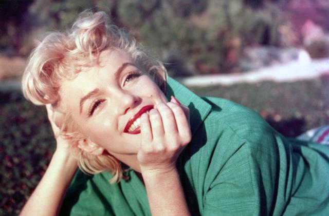 PALM SPRINGS, CA - 1954: Actress Marilyn Monroe poses for a portrait laying on the grass in 1954 in Palm Springs, California. (Photo by Baron/Getty Images)